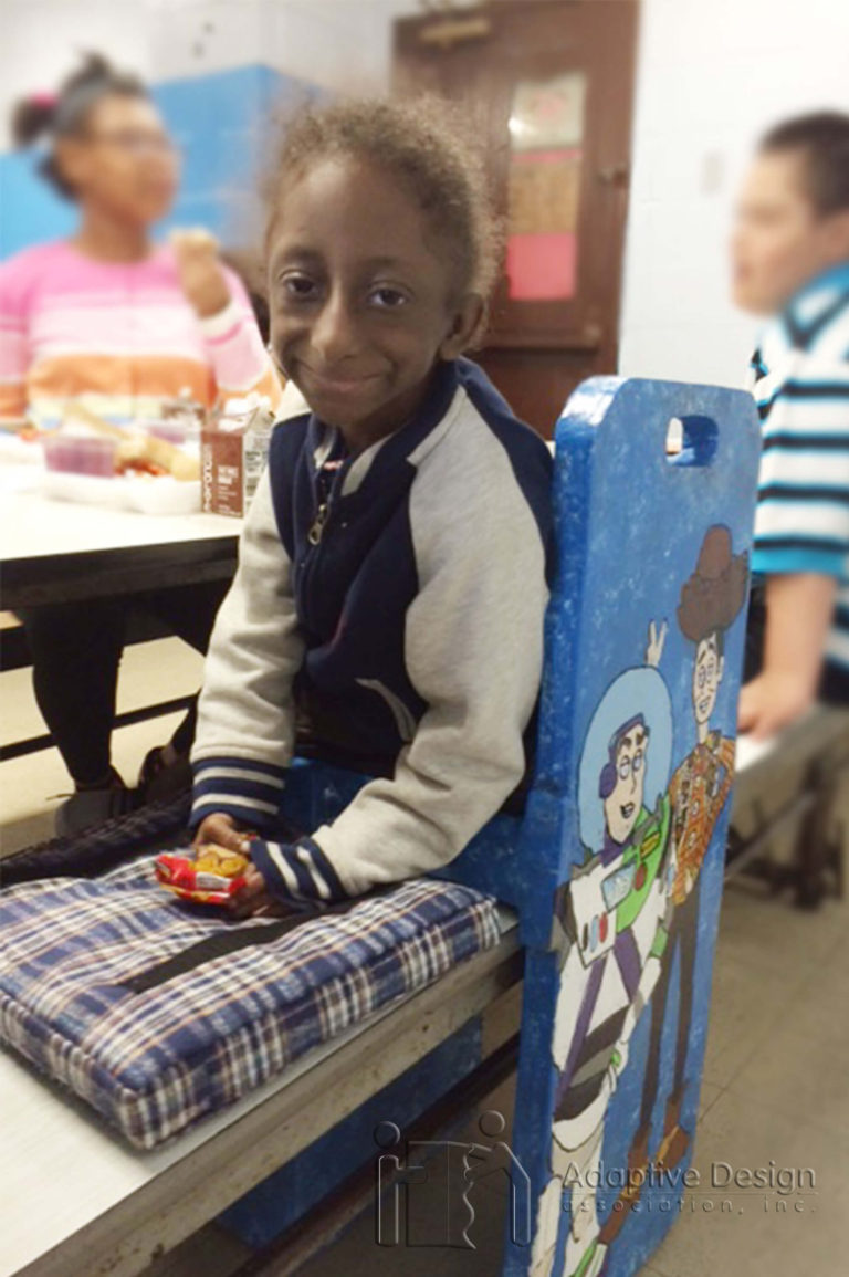 Jawan's Cafeteria Bench slips over the existing bench and allows him to eat at the same table with his friends